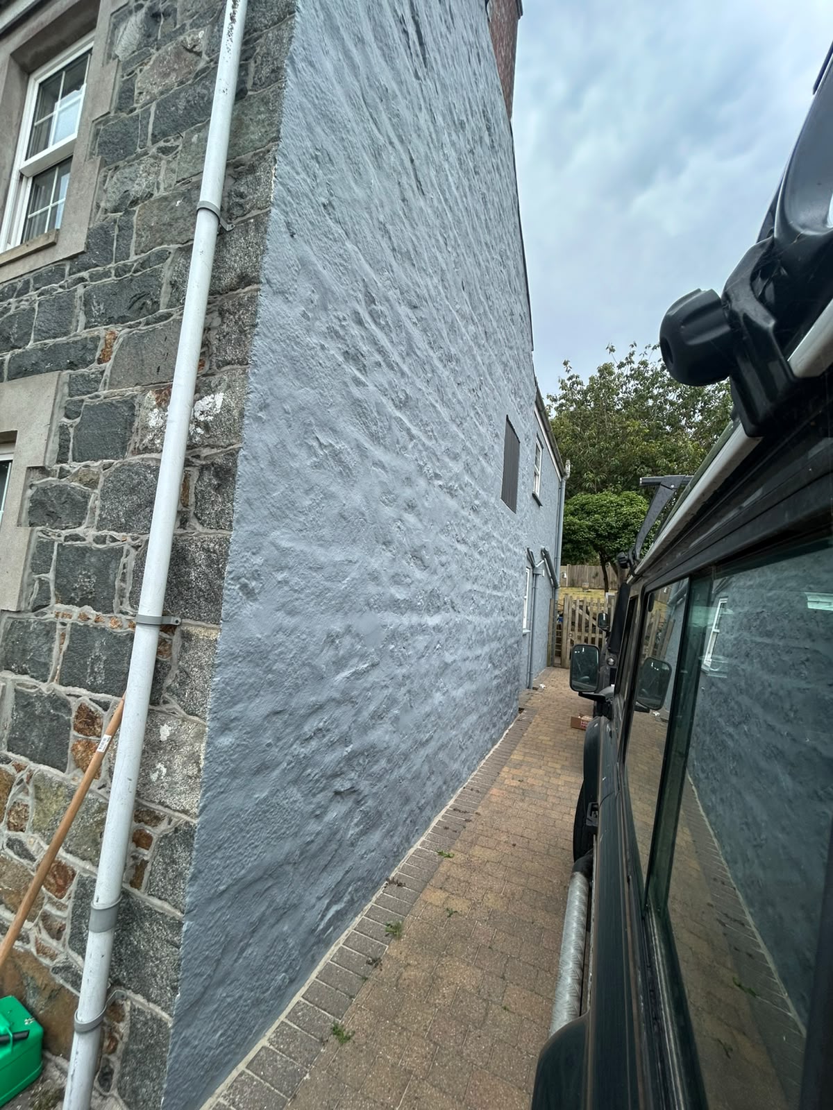 Painted coping stones and boundary walls on a Guernsey home exterior