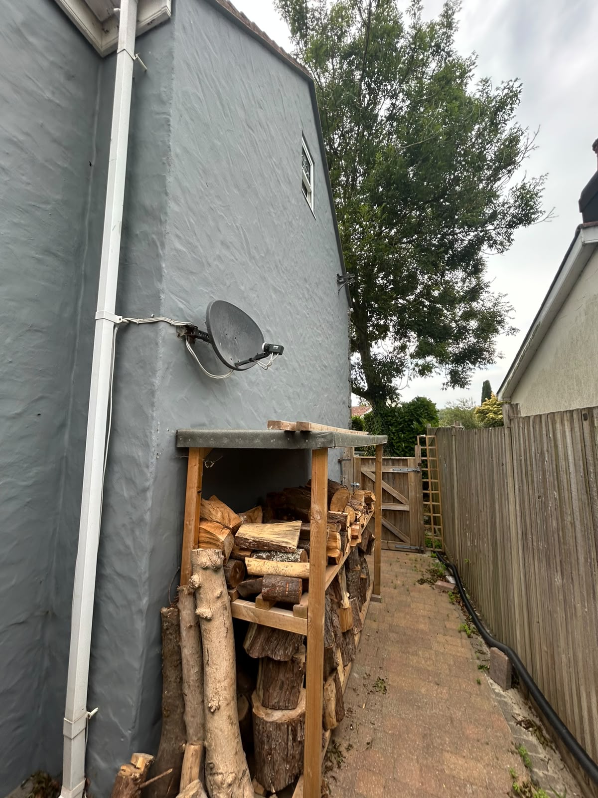 Before and after exterior repaint of a Guernsey home by Woody's Decorating