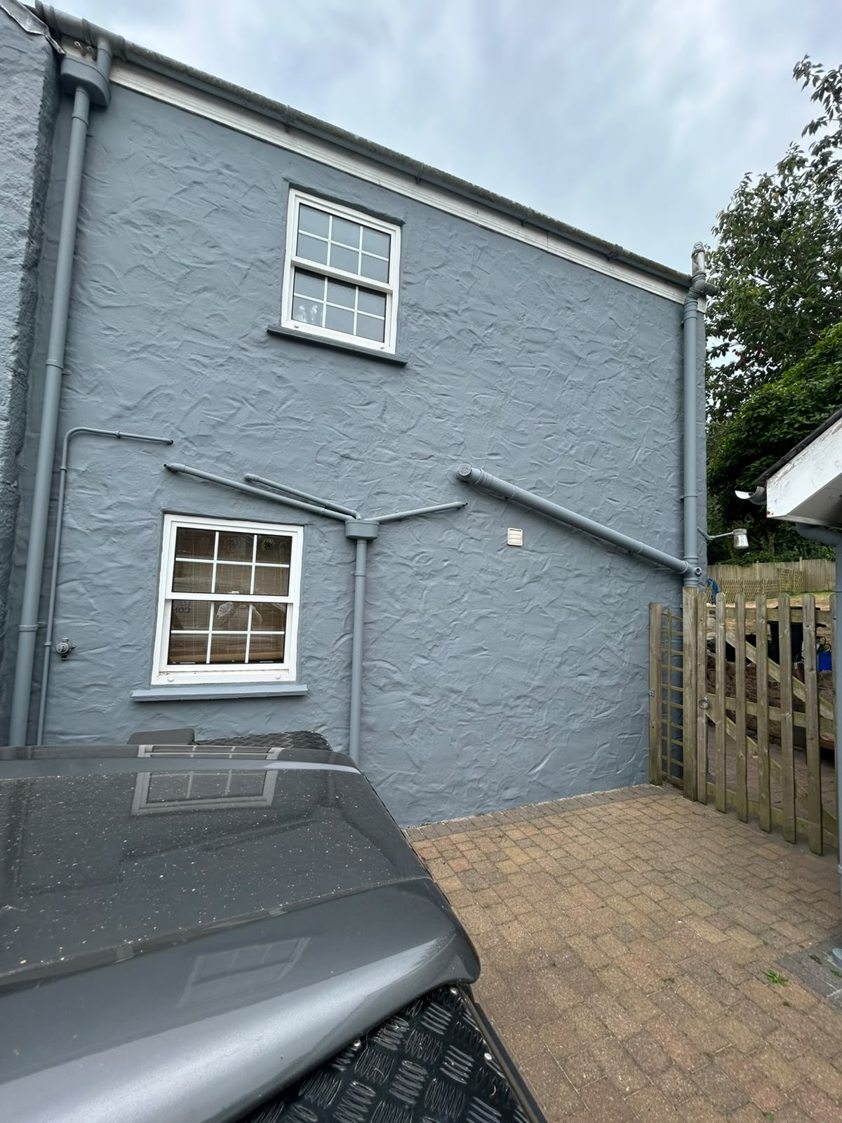 Rear courtyard with slate grey render and matching boundary walls