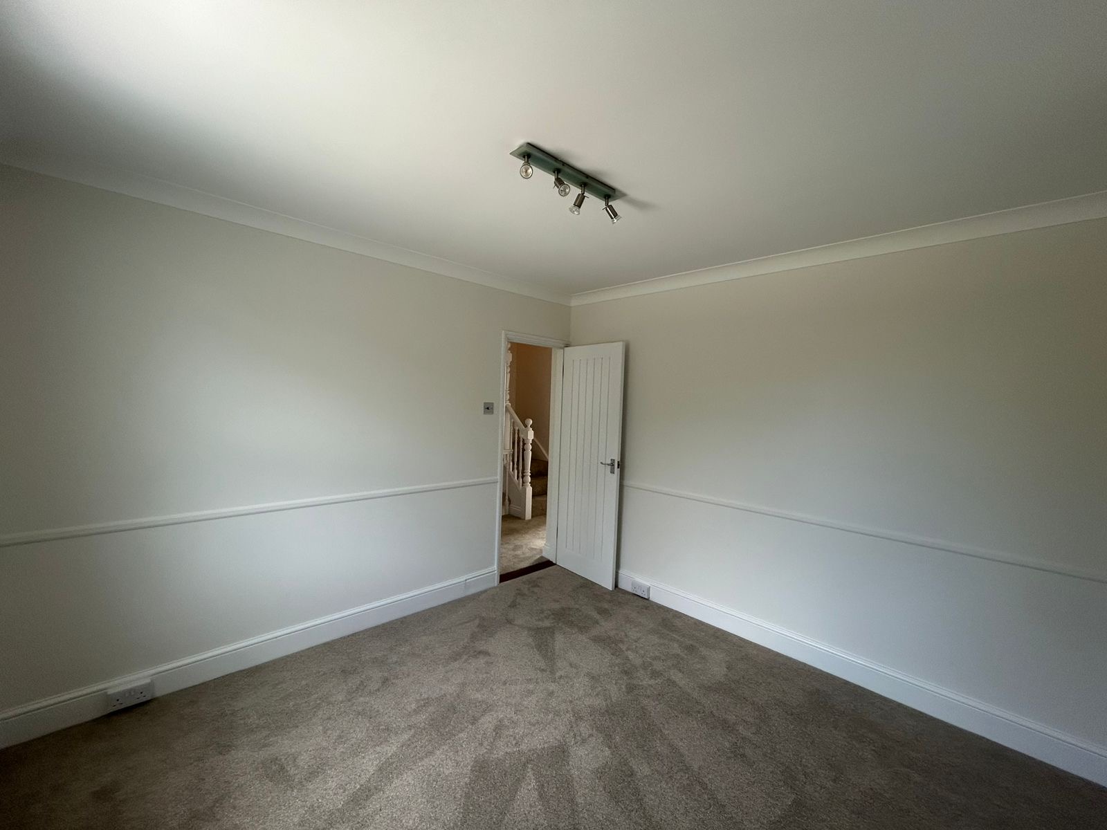 Bedroom with painted dado rail, neutral walls and white trim