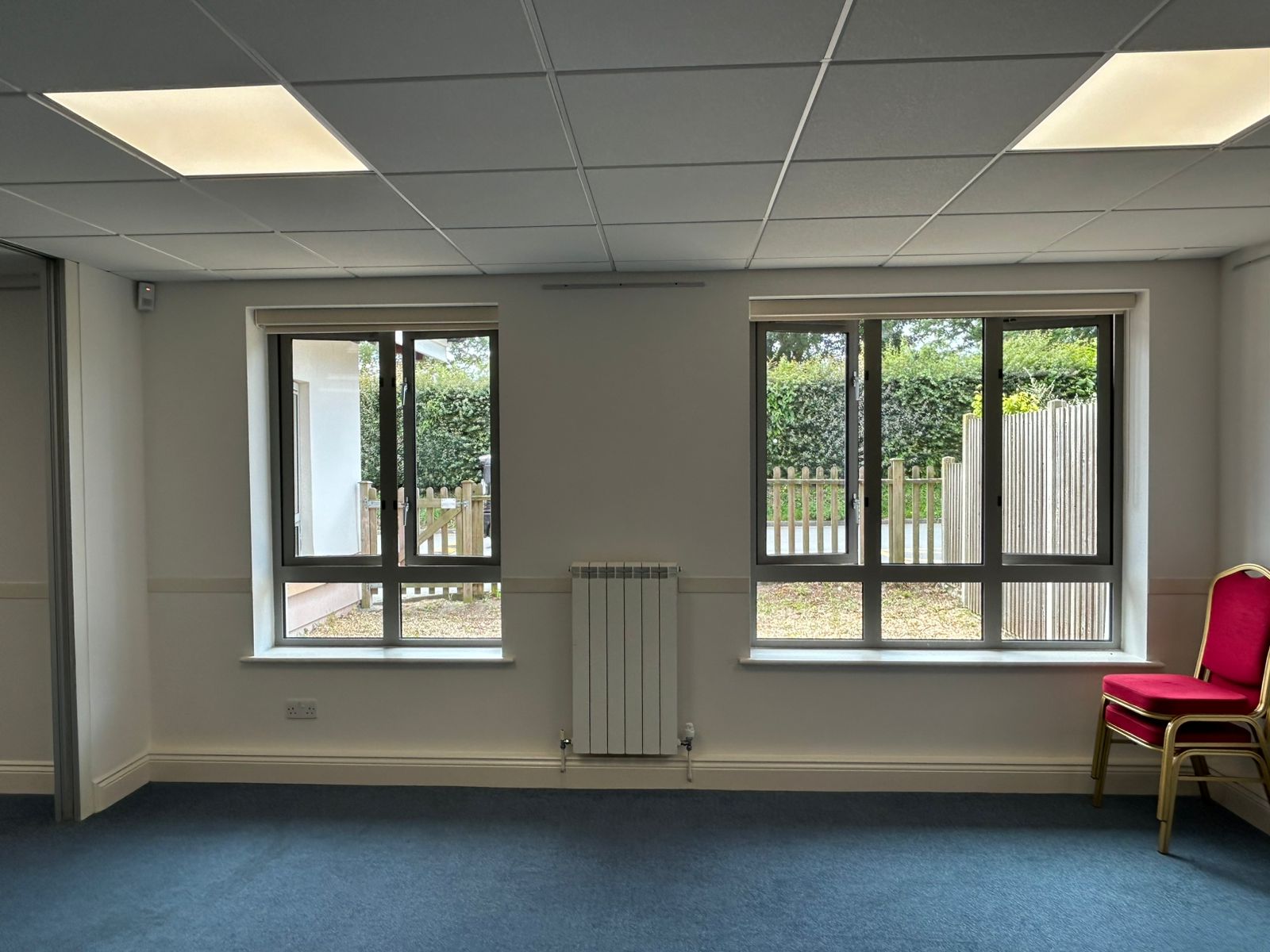 Meeting room with large windows and freshly painted white walls