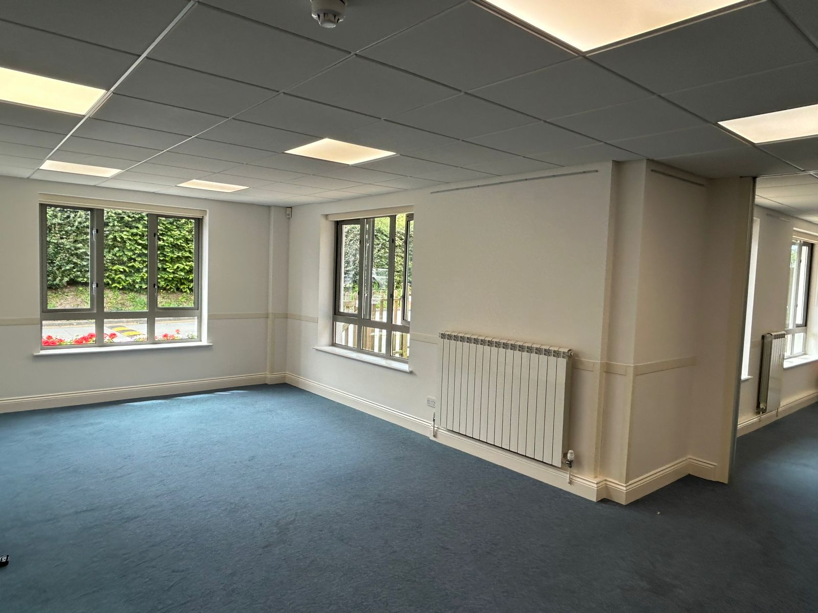 Community room with repainted radiator, dado rail and neutral walls