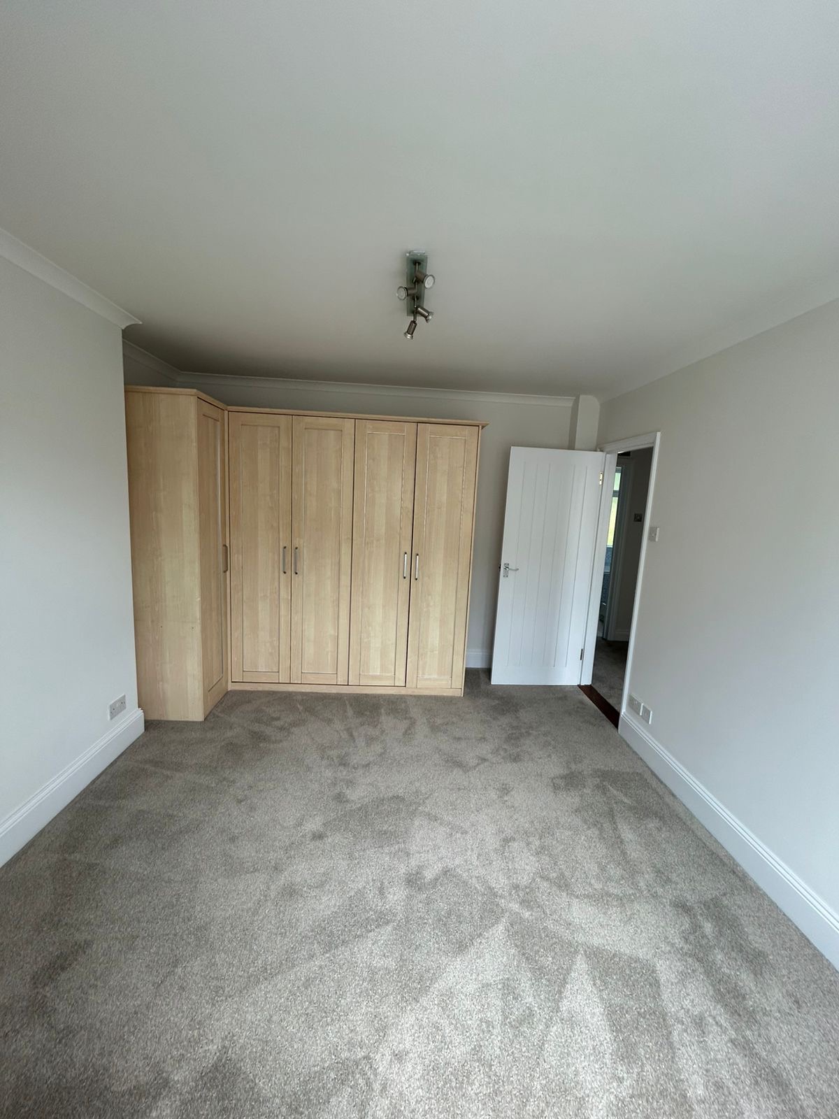 Master bedroom with fitted wardrobes and freshly painted walls and ceiling