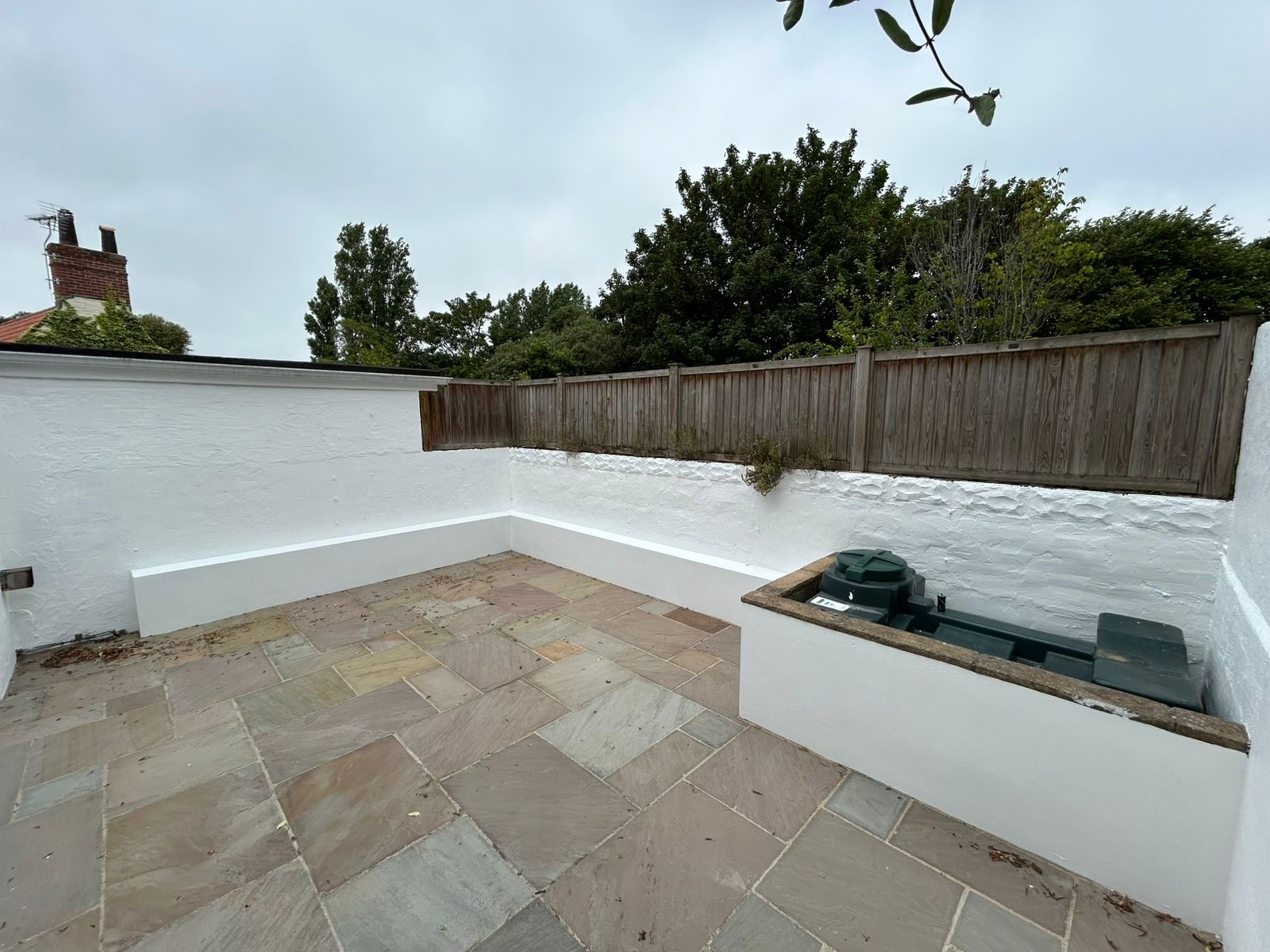 Woody's Decorating exterior painting project in Guernsey, white masonry finish