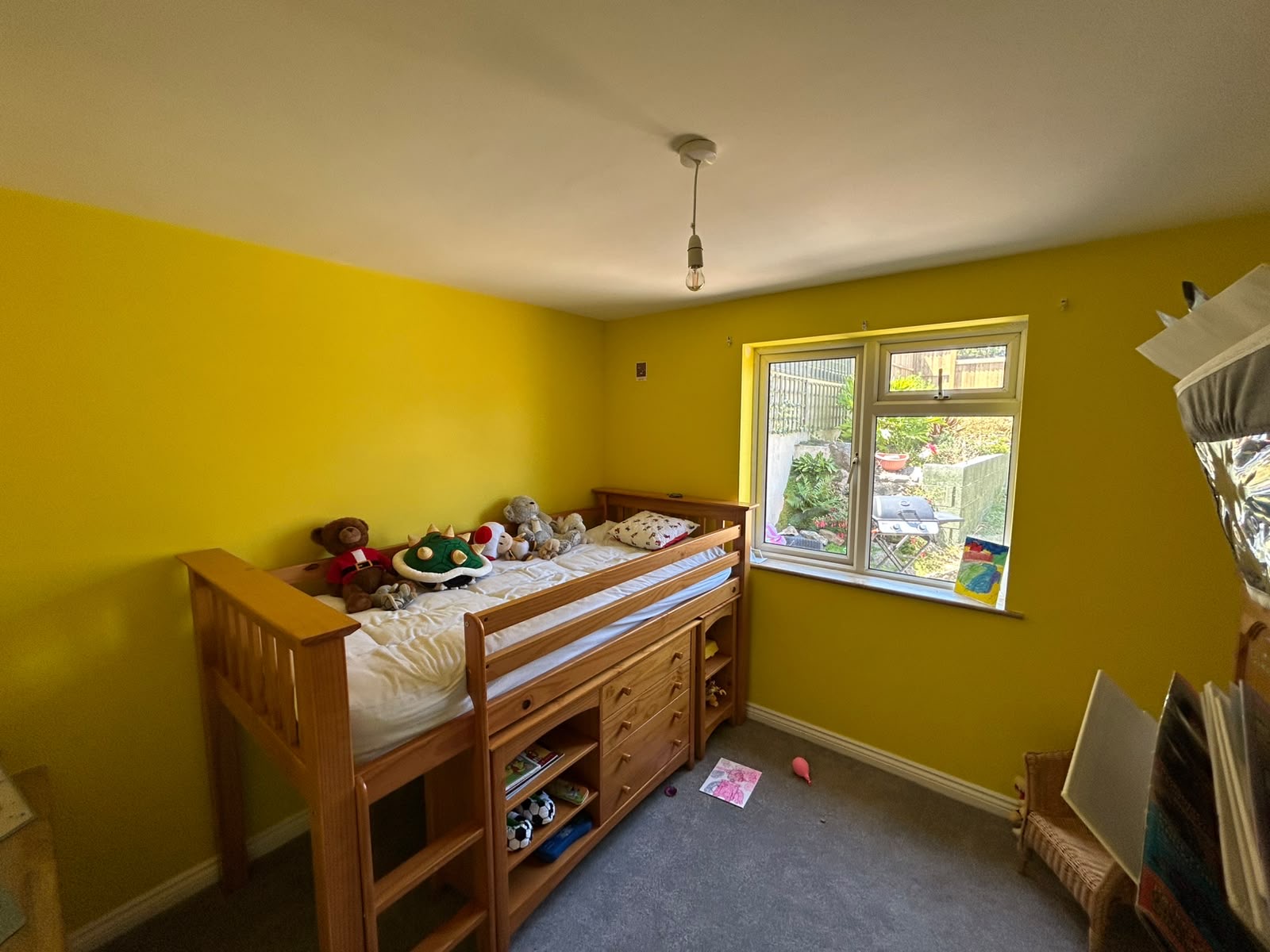 Child's bedroom in Caparol yellow with west-facing window and mid-sleeper bed