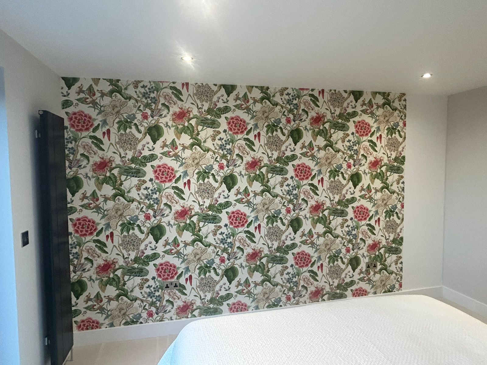 Floral wallpaper feature wall hung in a Guernsey bedroom