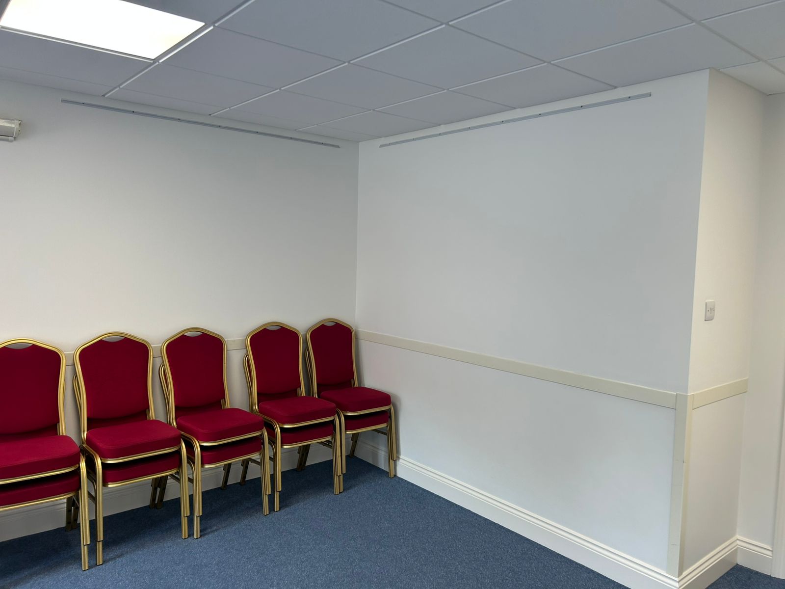Corner of hall with clean painted dado rail, skirting and trim