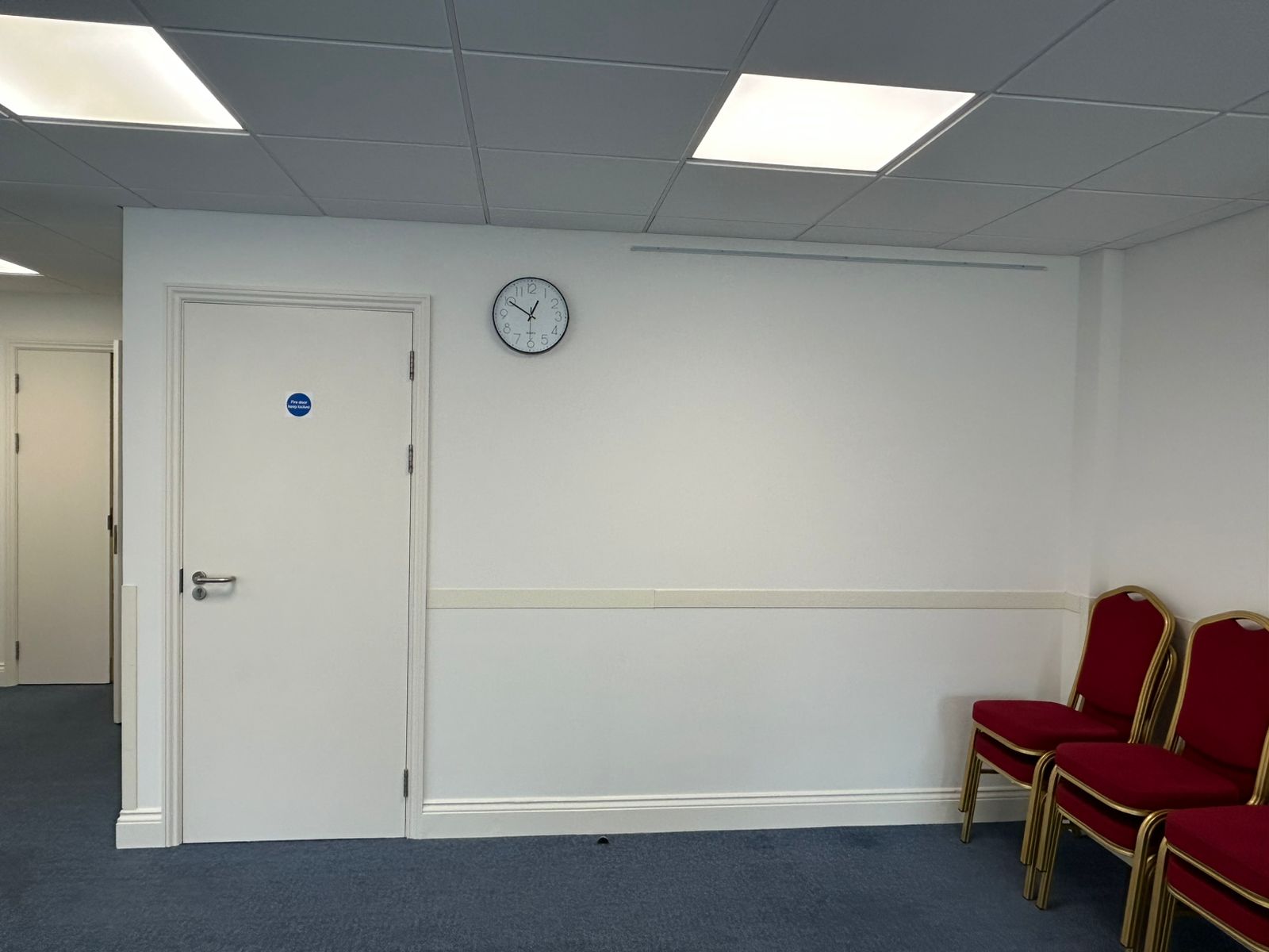 Commercial meeting room with painted fire door and dado rail