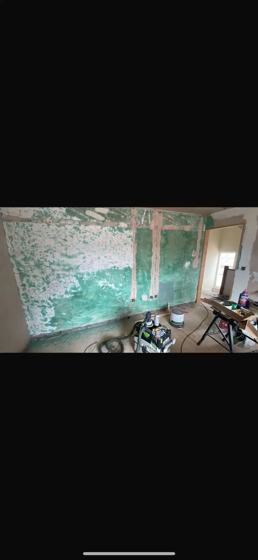 Room before — bare plasterboard walls and concrete floor