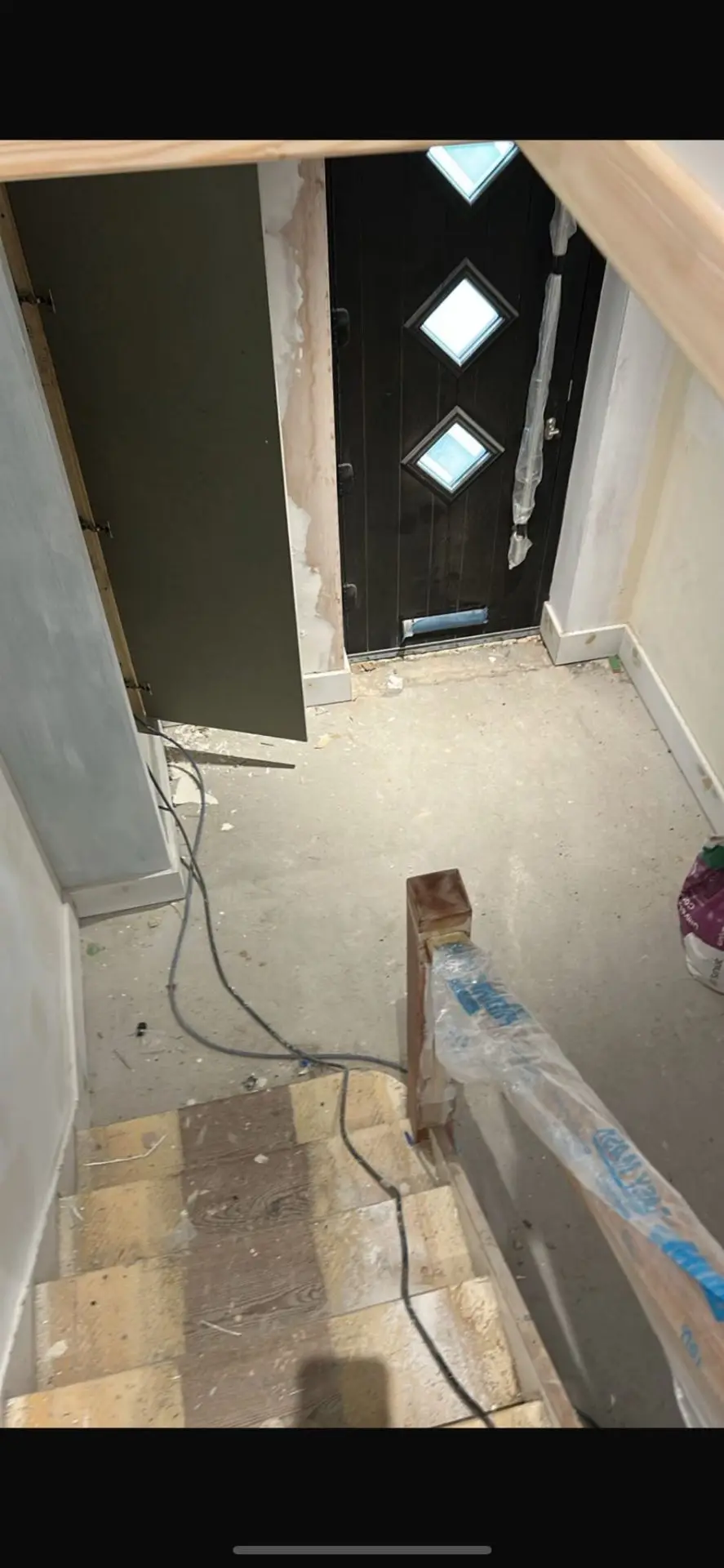 Doorway before — exposed timber framing and plasterboard