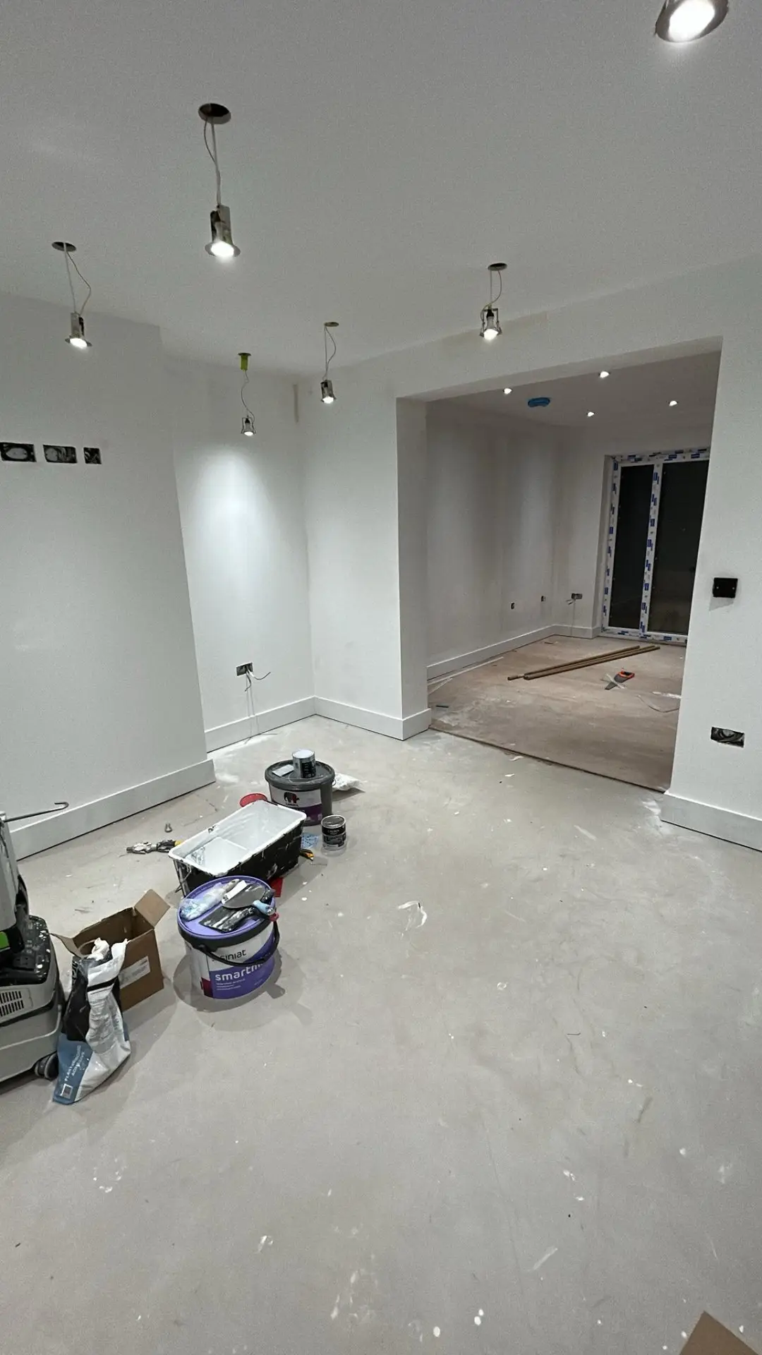 Finished living room with painted walls, ceiling lights and open-plan layout
