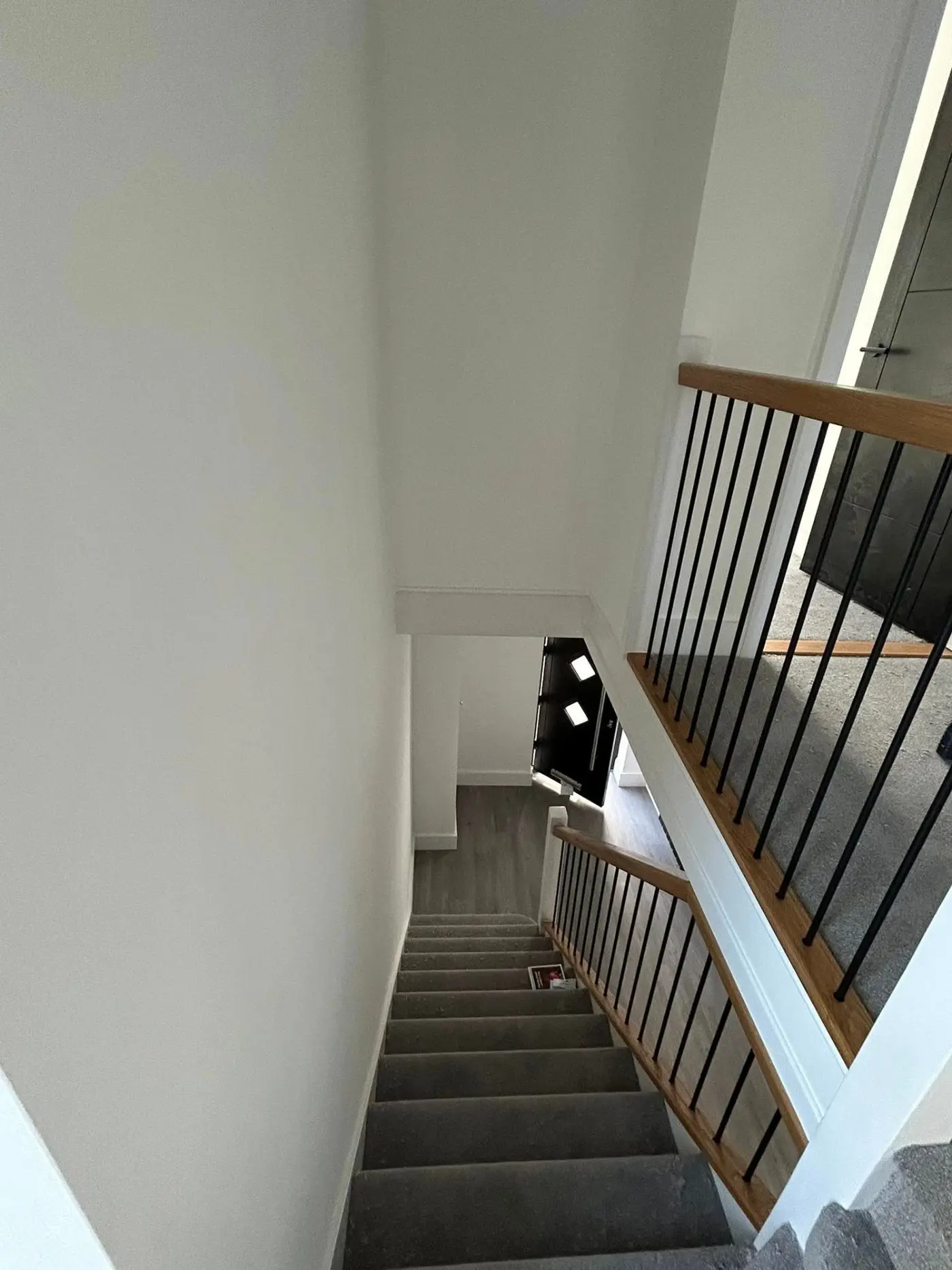 Staircase view looking down with oak and metal balustrade