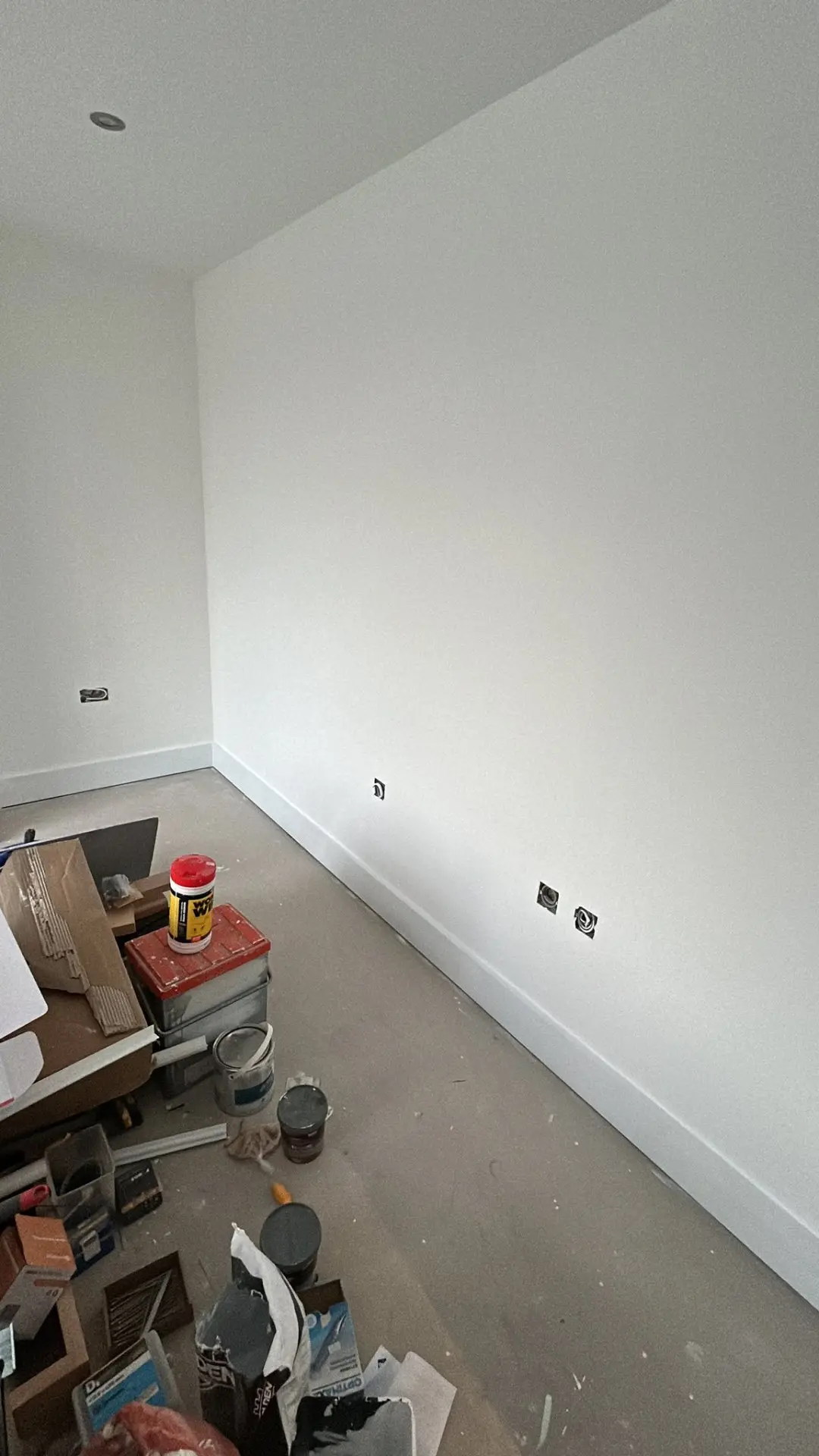 Upper bedroom with sloped ceiling, freshly painted white walls