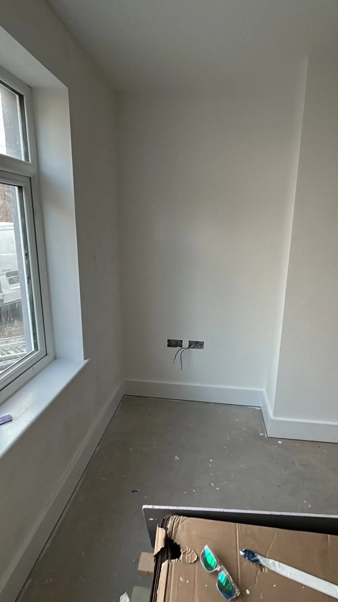 Bedroom with window, clean white walls and skirting boards