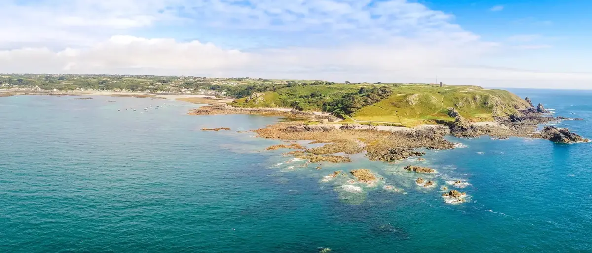 Aerial view of the Guernsey coastline with coastal properties overlooking the sea