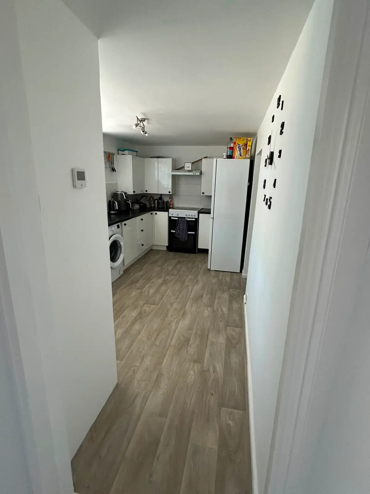 Kitchen finished in wipeable, hard-wearing white with wall clock feature