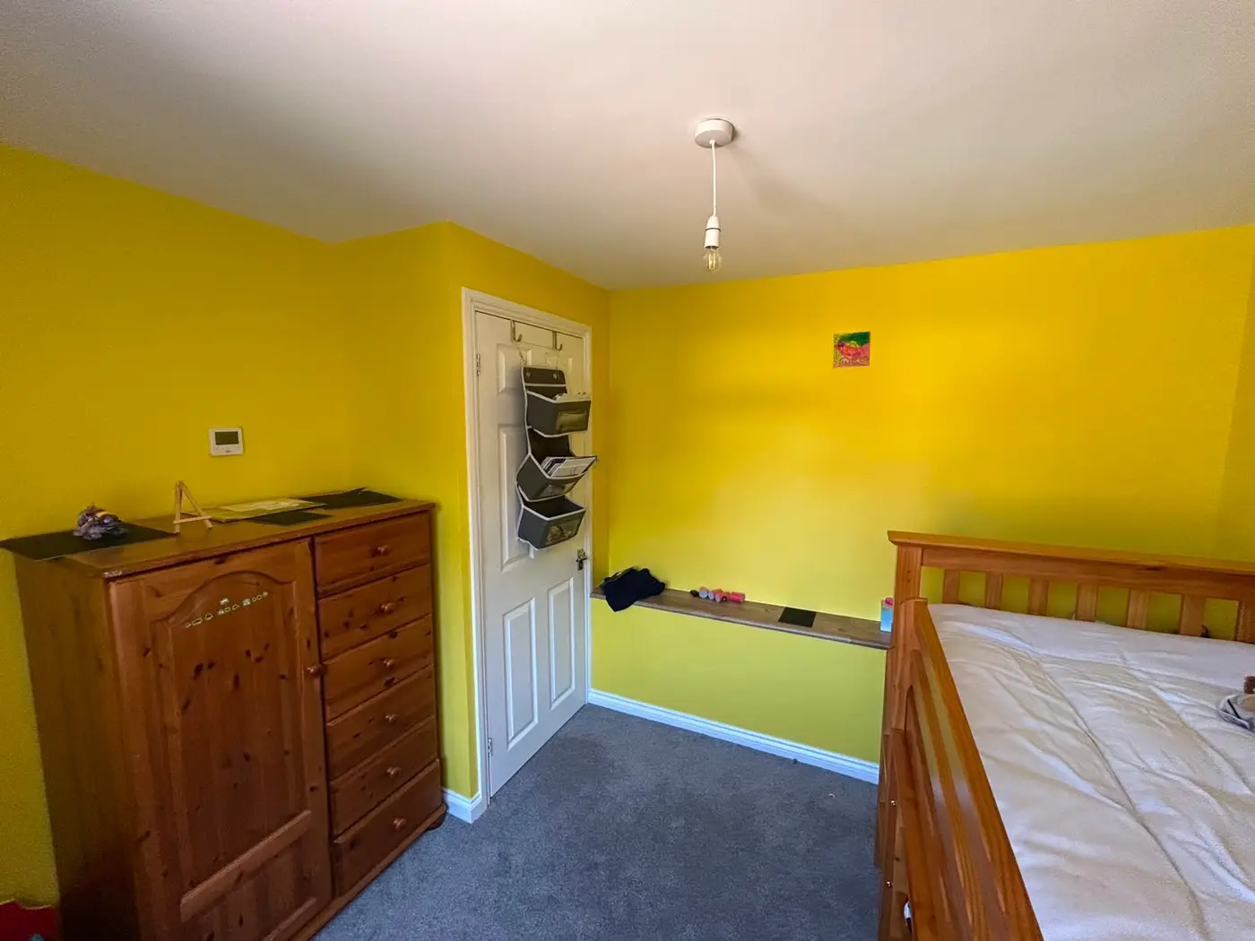 Bold Caparol yellow feature walls with white ceiling and trim