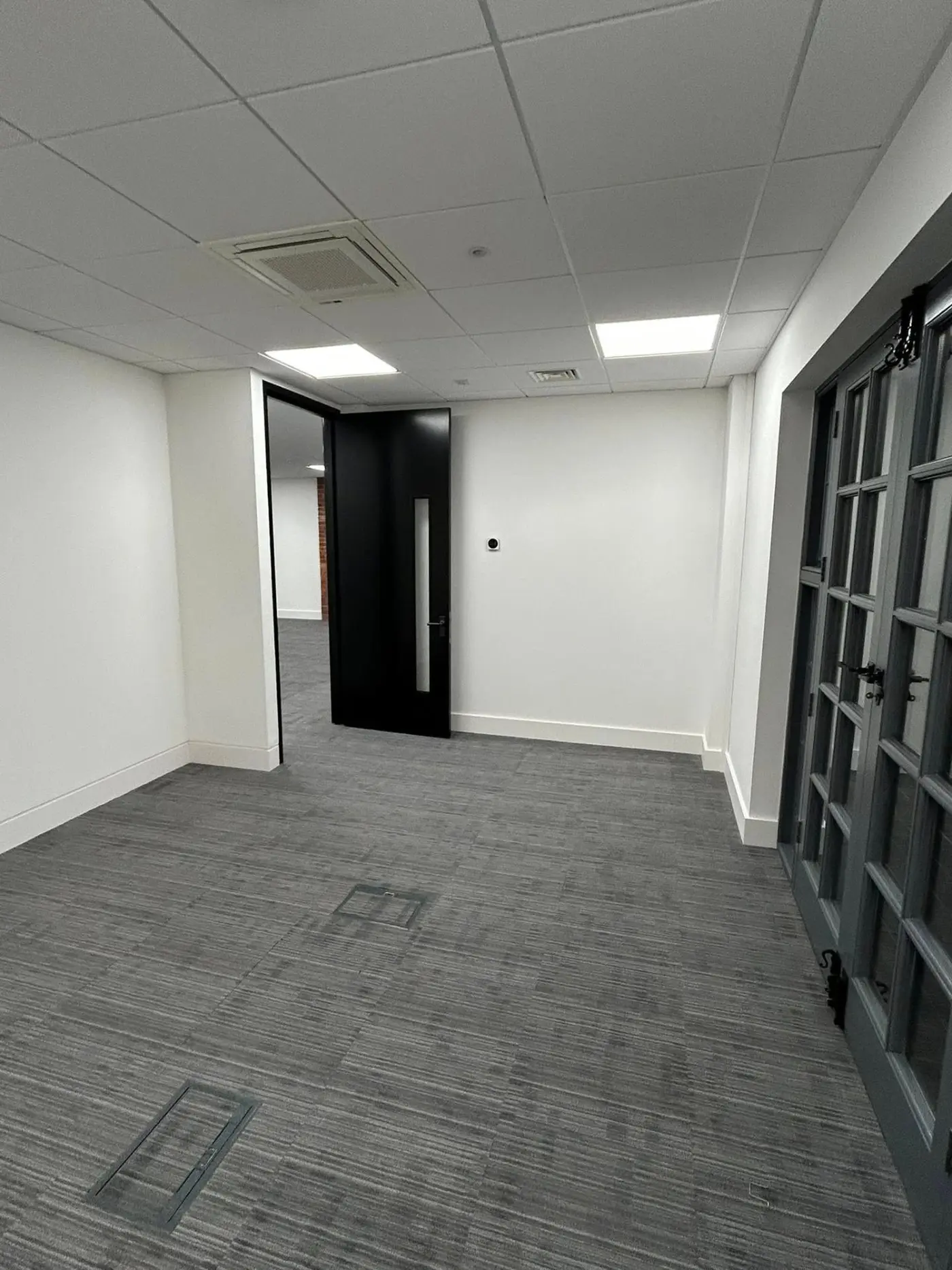 Office space with black door and French windows
