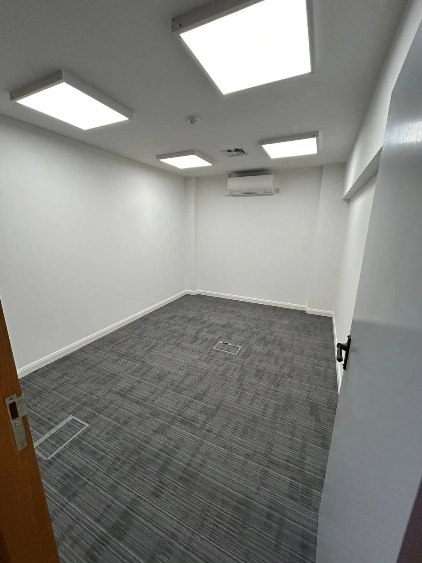 Smaller office room with clean white walls