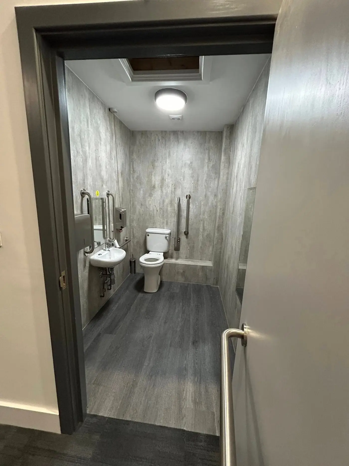 Accessible bathroom with grey wall panels
