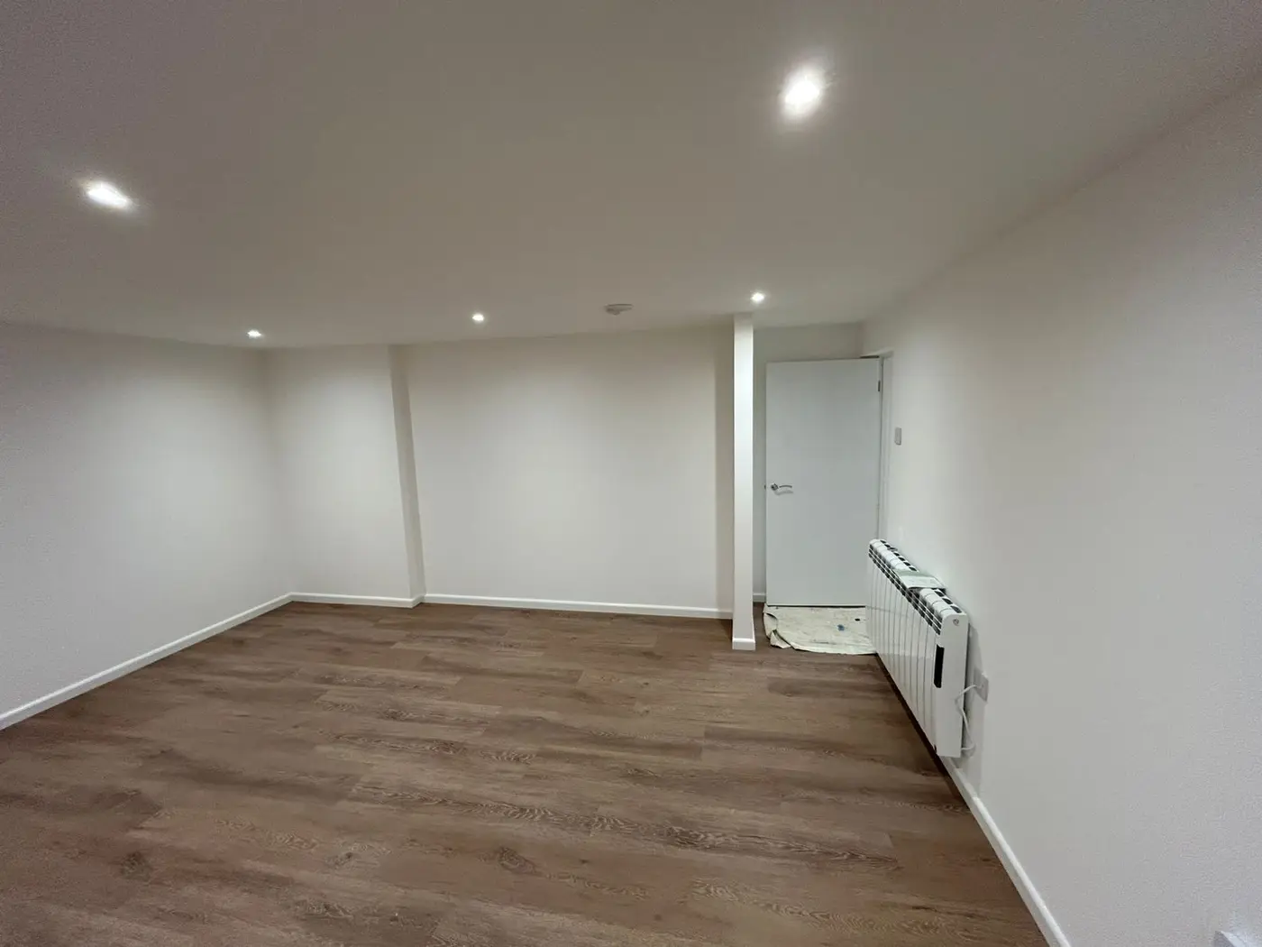 Living space with fresh paint and wooden flooring