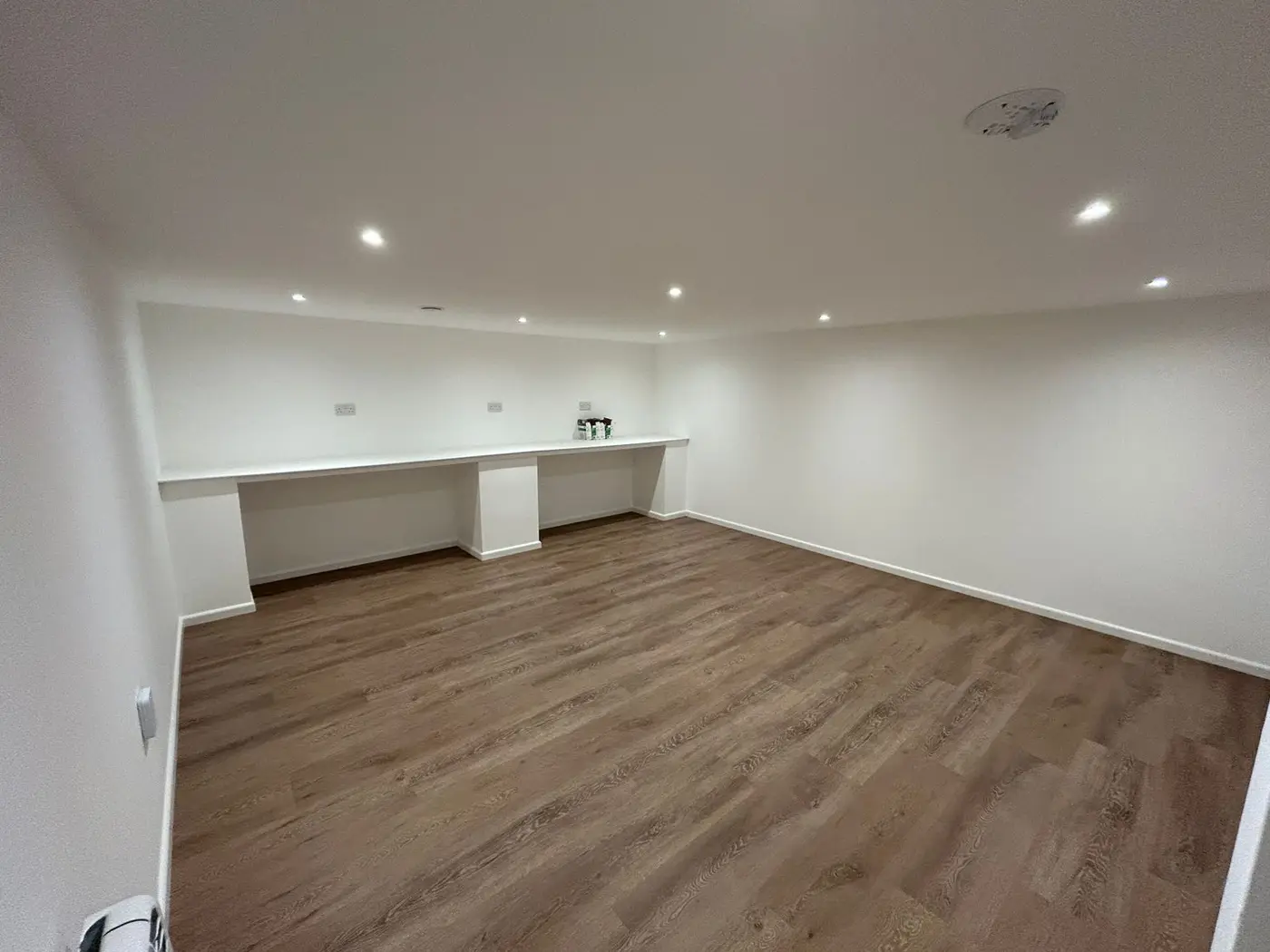 Open room with built-in desk area, freshly decorated