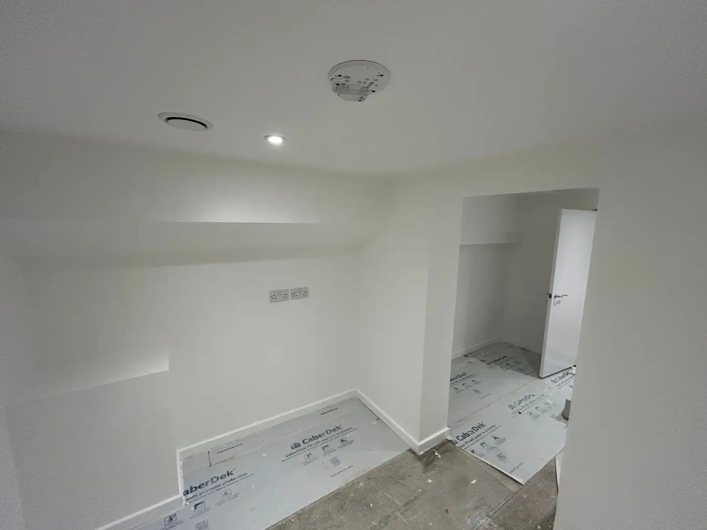 Loft bedroom with sloped ceilings, fully painted