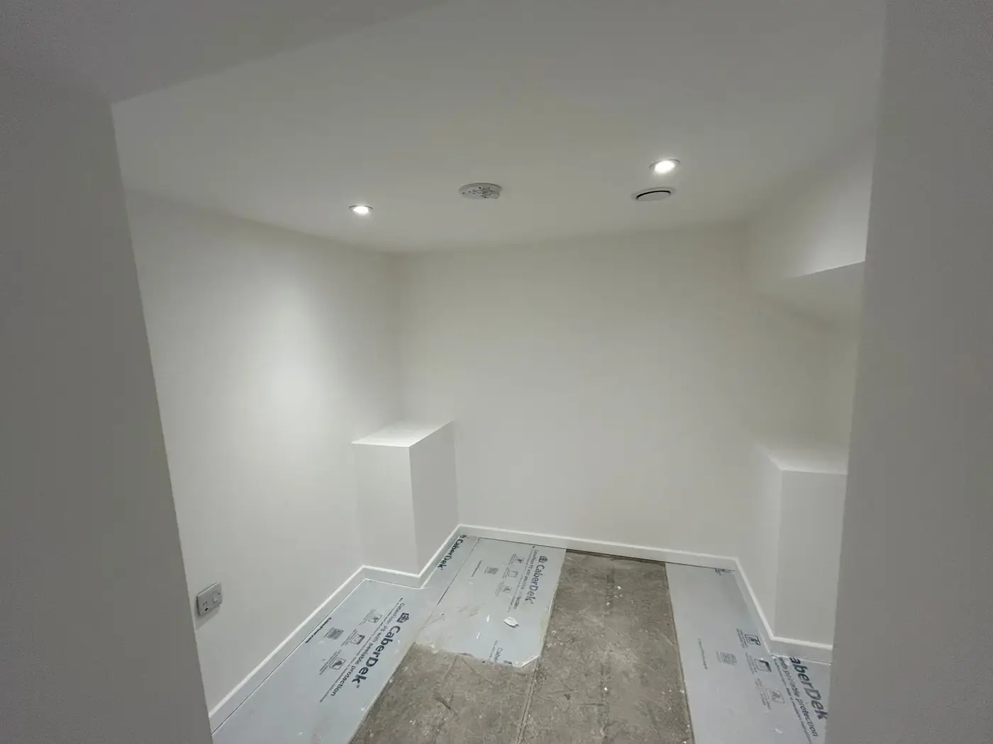 Bedroom with angled walls, clean white finish