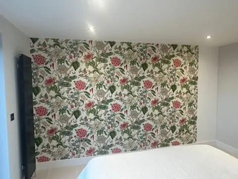 Feature wall with patterned wallpaper hung by Woody's Decorating in a Guernsey home